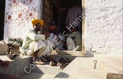 Men sitting talking in doorway Jaisalmer 863302
