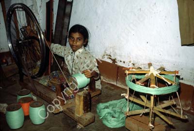 Child labour girl spinning thread 827010