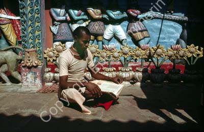 Man brahmin reading outside temple Puri 858907