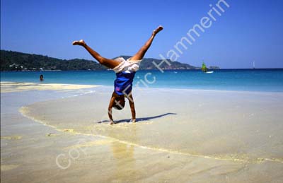 Girl cartwheeling on the beach 8721415