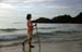 Girl with stick on the beach 8720930