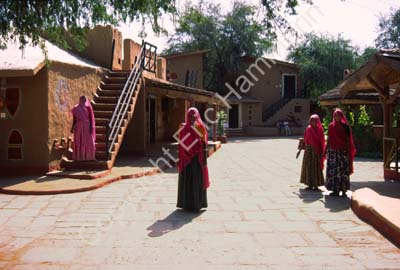Women in street among bungalows Chowkidhani 005038