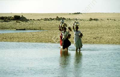Women with jars on head crossing river Dwarka 861426