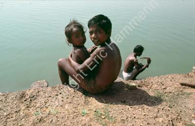 Children sitting by pond Puri 858835