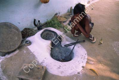 Boy by the stove outdoors Rajasthan 004445