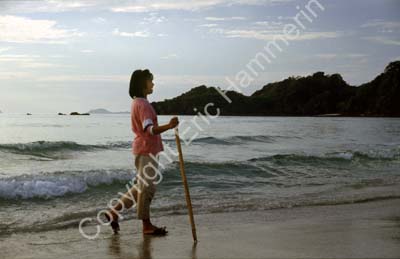 Girl with stick on the beach 8720930